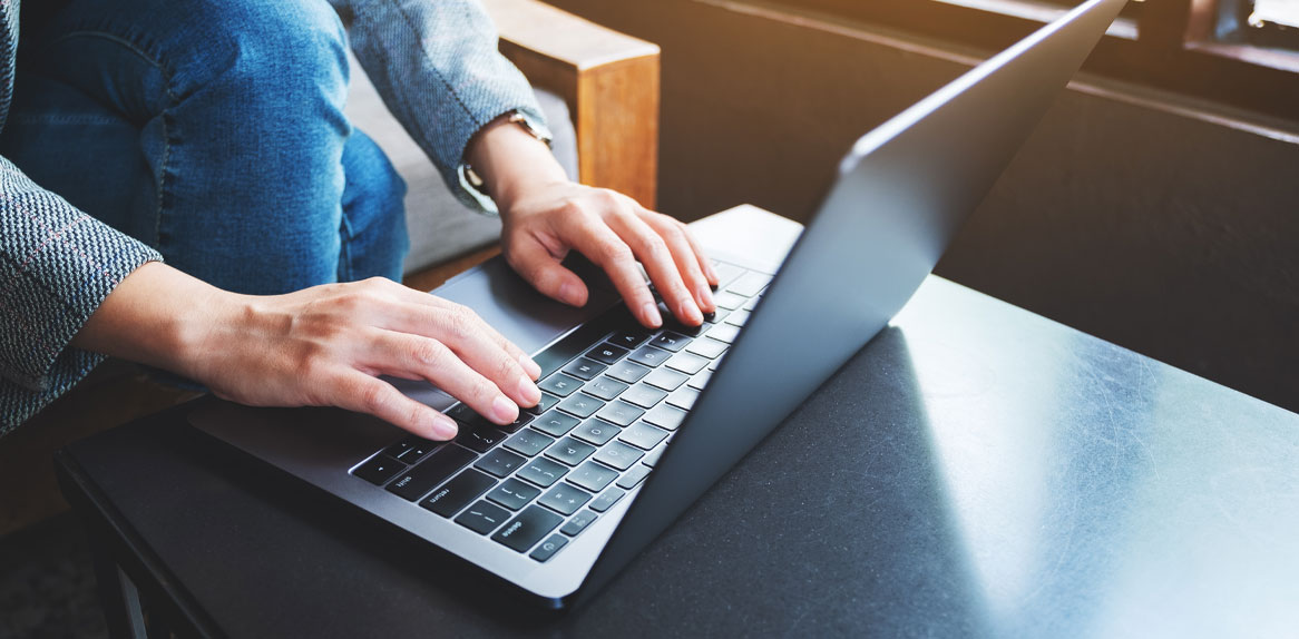a man typing on a laptop